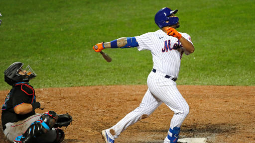 Dominic Smith watches a ball go over the fence as he nets a grand slam